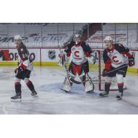 Prince George Cougars defencemen Keaton Dowhaniuk (left) and Ethan Samson flank goaltender Ty Young