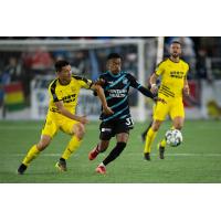 Colorado Springs Switchbacks FC forward Deshane Beckford (center) vs. New Mexico United