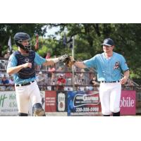 St. Cloud Rox catcher Nate Peterson bumps gloves with Caleb Ricketts