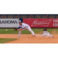 Tulsa Drillers second baseman Michael Busch tries to catch the Arkansas Travelers runner from stealing second