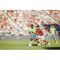 Seattle Sounders FC defender Y. Gomez Andrade (left) battles the Colorado Rapids