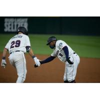 Cal Raleigh of the Tacoma Rainiers receives congratulations while circling the bases