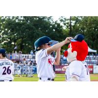 Kevin Davis swaps caps with St. Cloud Rox mascot Chisel