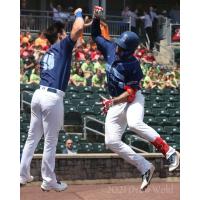 New York Boulders' Ray Hernandez (right) gets congratulated by teammate Zach Kirtley after connecting for a solo home run