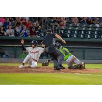 Charcer Burks of the Kansas City Monarchs slides in ahead of the tag of the Kane County Cougars' BJ Lopez