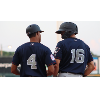 Somerset Patriots coach Jose Javier and outfielder Brandon Lockridge (16)