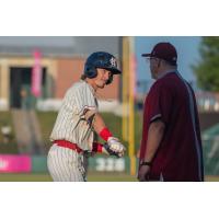 Kansas City Monarchs second baseman Ryan Grotjohn celebrates one of his two RBI against the Houston Apollos with third base coach Bill Sobbe