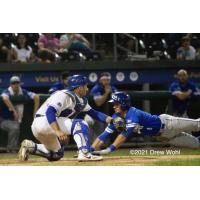 Equipe Quebec's Jonathan Lacroix's headfirst slide eludes tag of New York Boulders' catcher Phil Capra