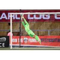 Atlético Ottawa goalkeeper Nathan Ingham stretches to make a save