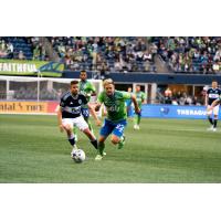 Seattle Sounders FC midfielder Kelyn Rowe races for the ball