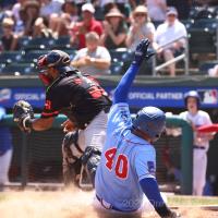 New York Boulders infielder Ray Hernandez slides safely into home against the Trois-Rivieres Aigles