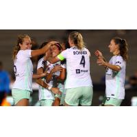 Racing Louisville FC midfielder Savannah DeMelo is congratulated by teammates