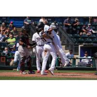 Tacoma Rainiers' Brian Erick Mejia congratulates Mason McCoy