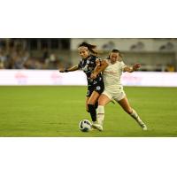 Racing Louisville FC forward Nadia Nadim (left) vs. the Portland Thorns