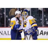 Saskatoon Blades centre Lukas Hansen congratulates goaltender Austin Elliott