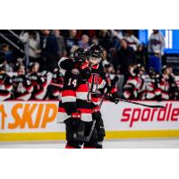 Belleville Senators forward Rourke Chartier receives a congratulatory hug against the Laval Rocket