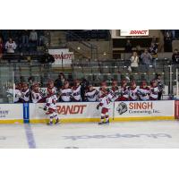 Rapid City Rush exchange high fives along the bench