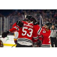 Rockford IceHogs' Buddy Robinson and Cole Guttman celebrate win