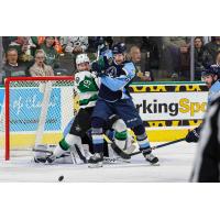 Texas Stars forward Cameron Hughes (left) fights for position against the Milwaukee Admirals